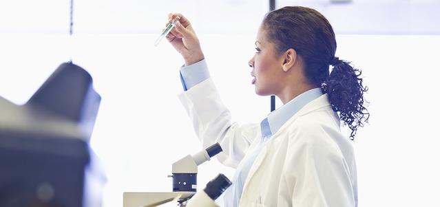 Un professionnel de la santé inspecte un tube à essai dans un laboratoire